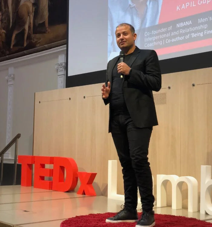 Kapil delivering a TEDx talk on stage